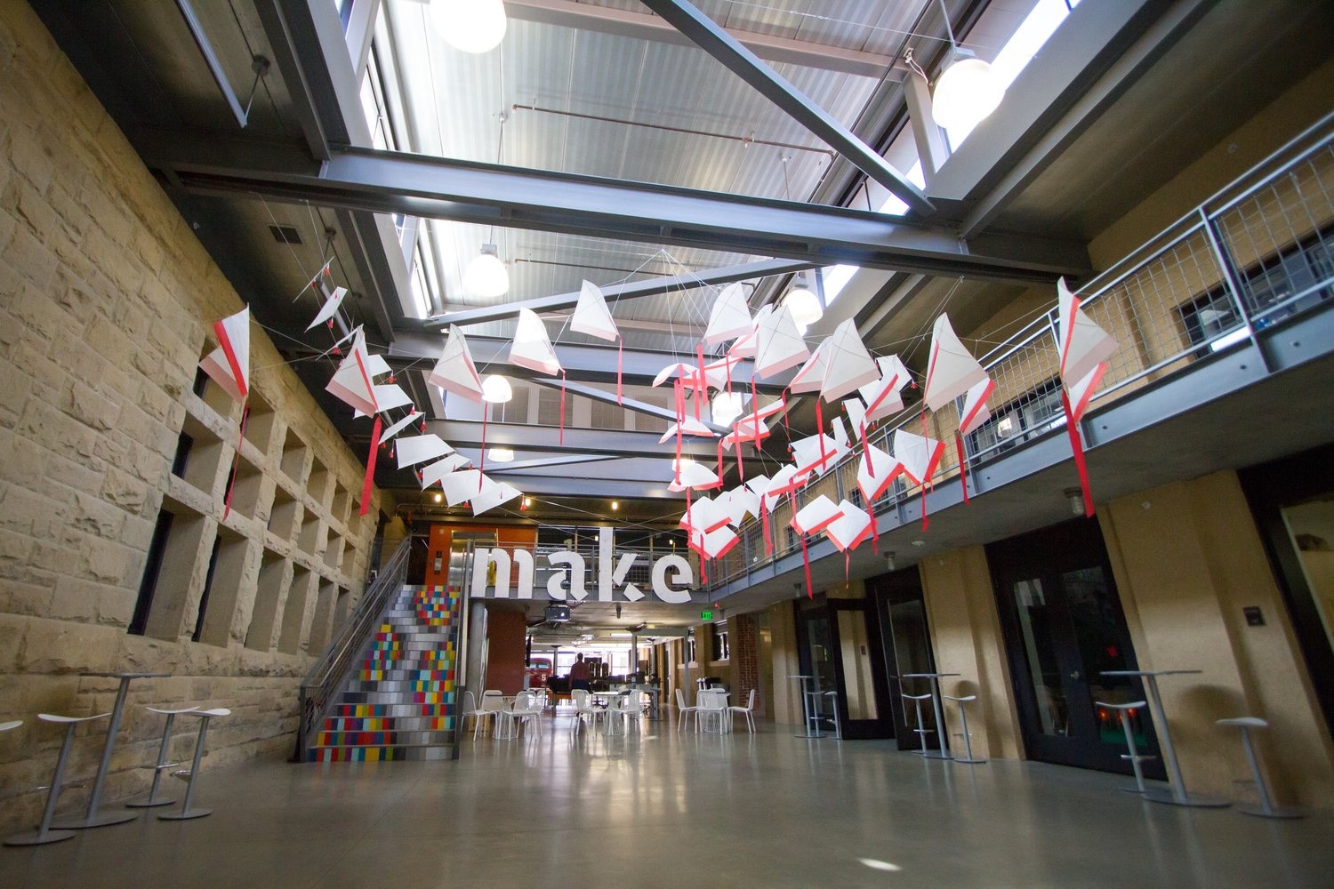 d.school atrium with hanging kites and the make sign